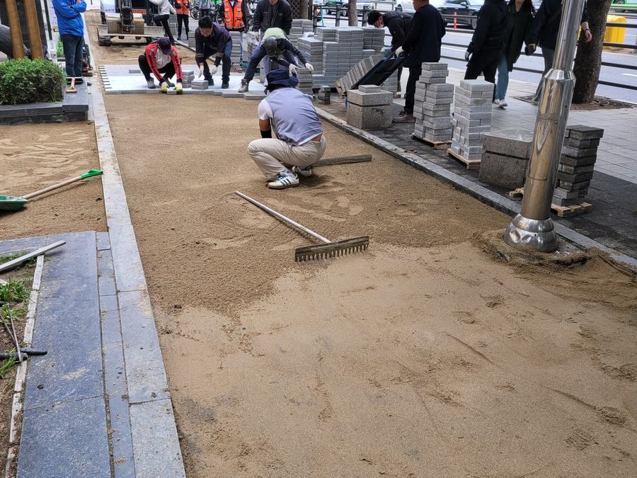 수평기를 바닥에 대고 구간별 높낮이 차이를 재는 모습